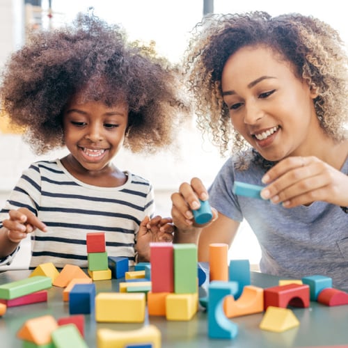 Mother and child playing with blocks