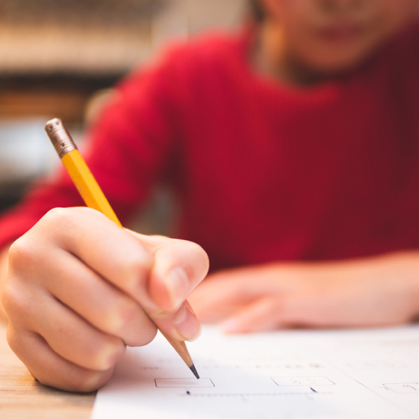 Boy writing with pencil