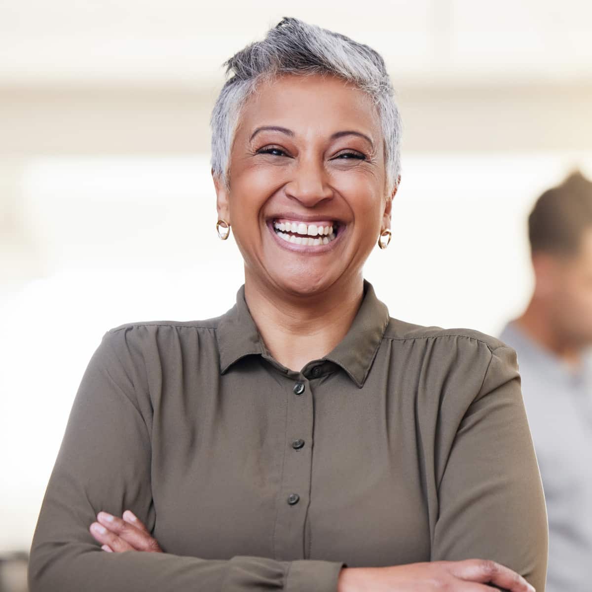 Business woman standing facing forward smiling. 