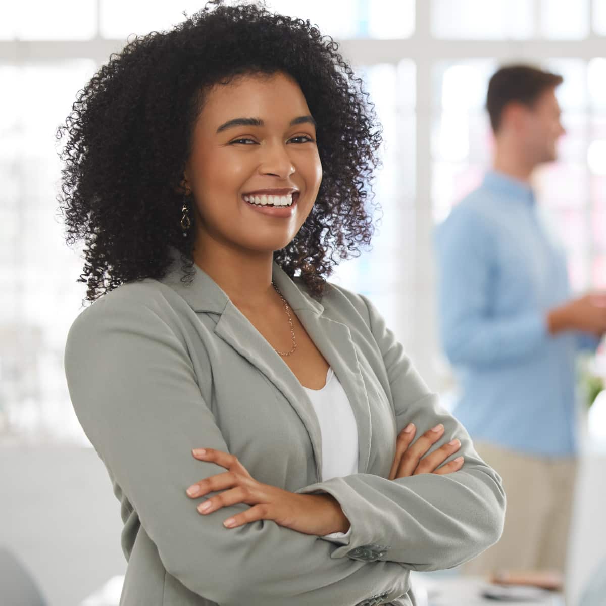 Business woman standing and facing forward smiling. 