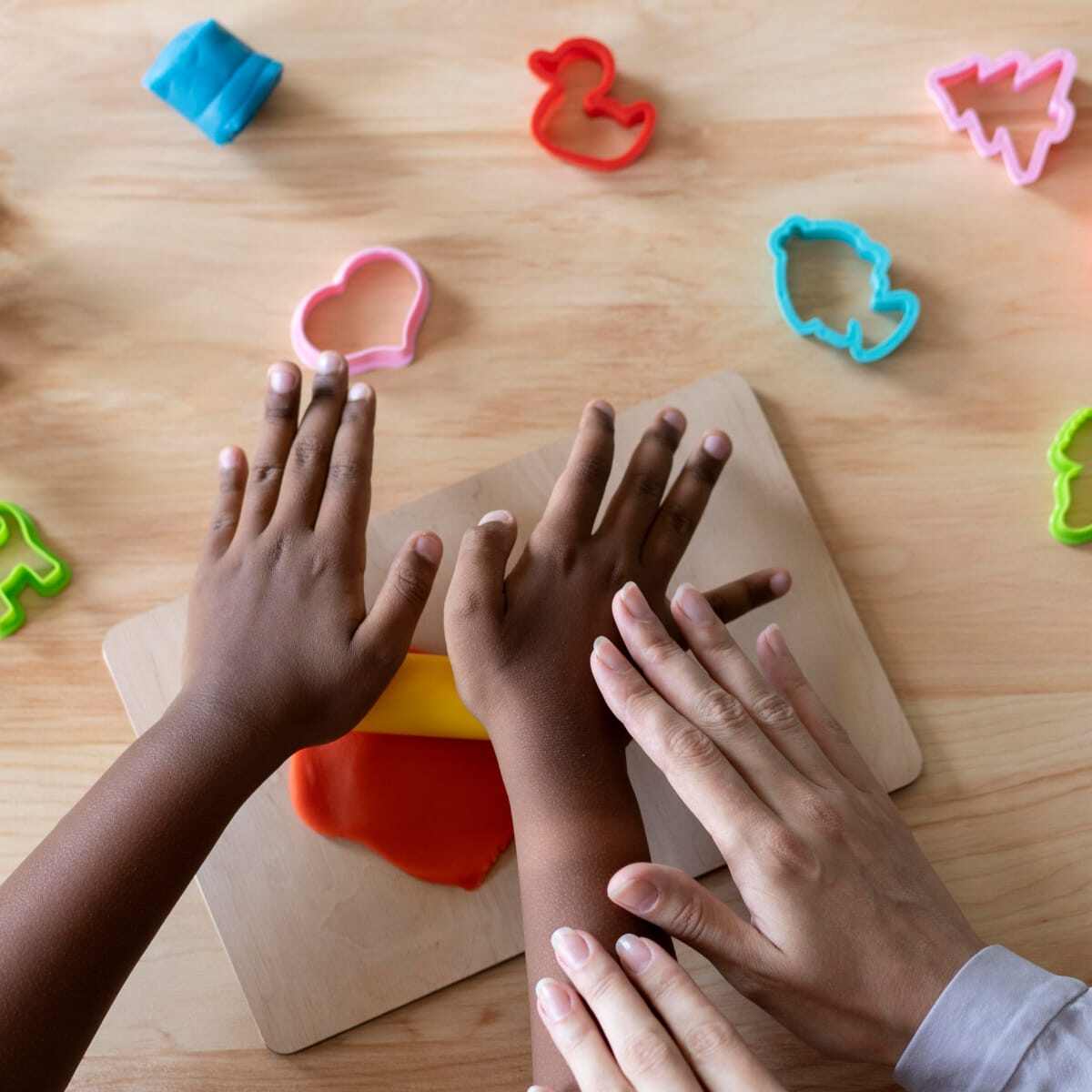 Colored child doing occupational therapy session with psychologist. 