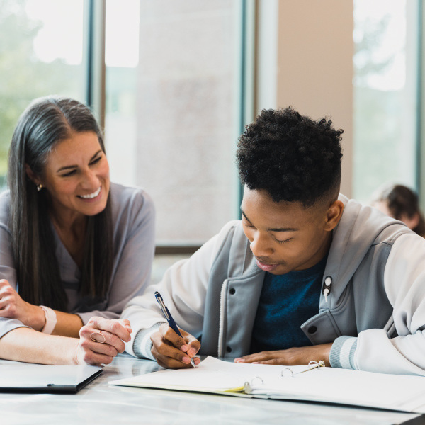 Teacher helping student