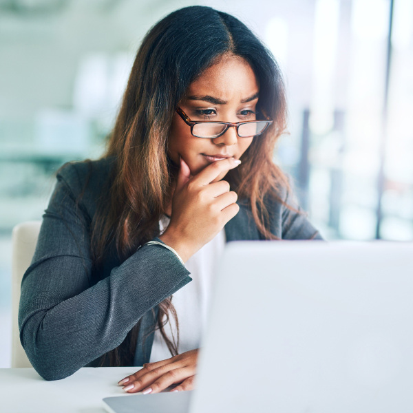 woman sitting at desk looking at laptop