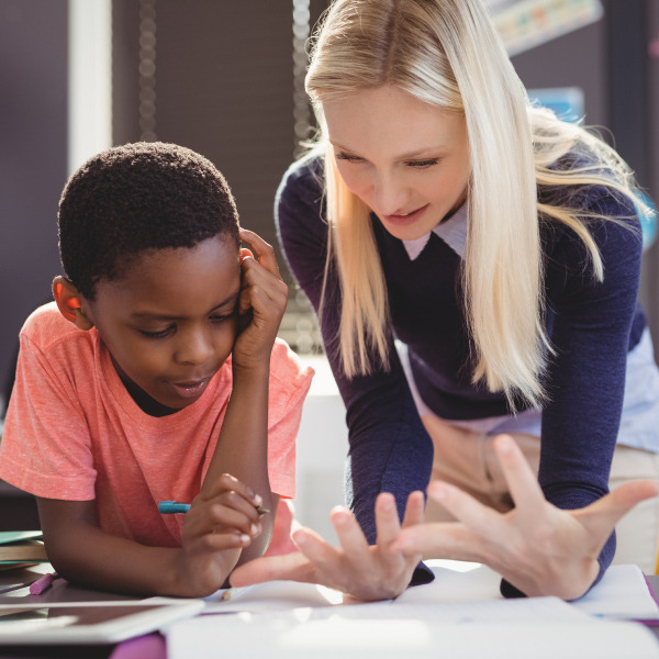 teacher and student working together in classroom