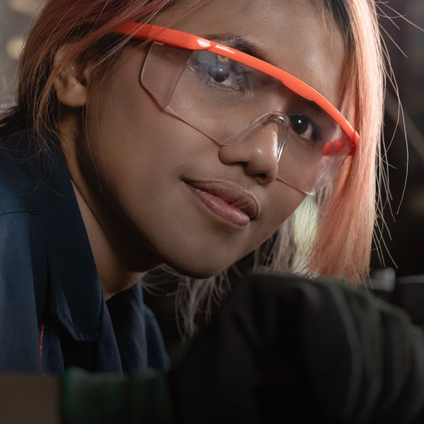 student wearing safety glasses working in shop