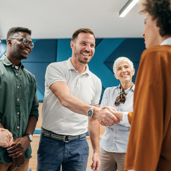 educators standing next to each other smiling shaking hands