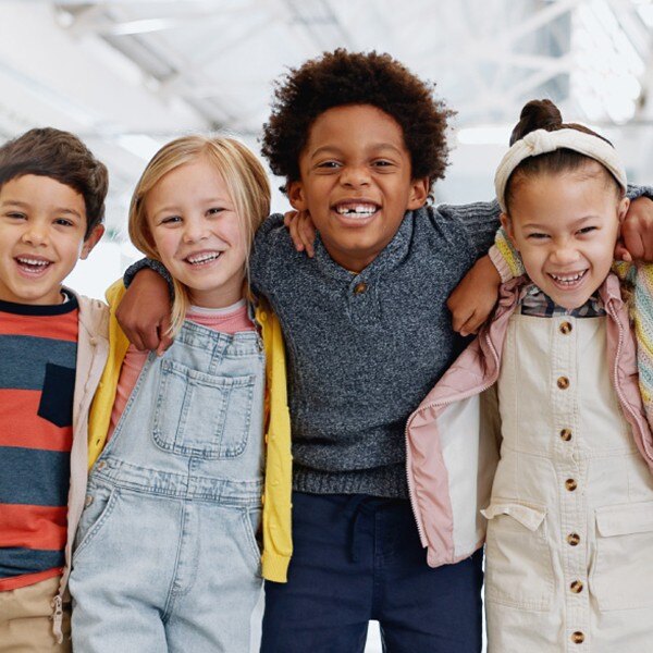 students standing side by side facing forward smiling