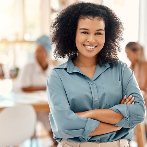 female worker standing facing forward smiling